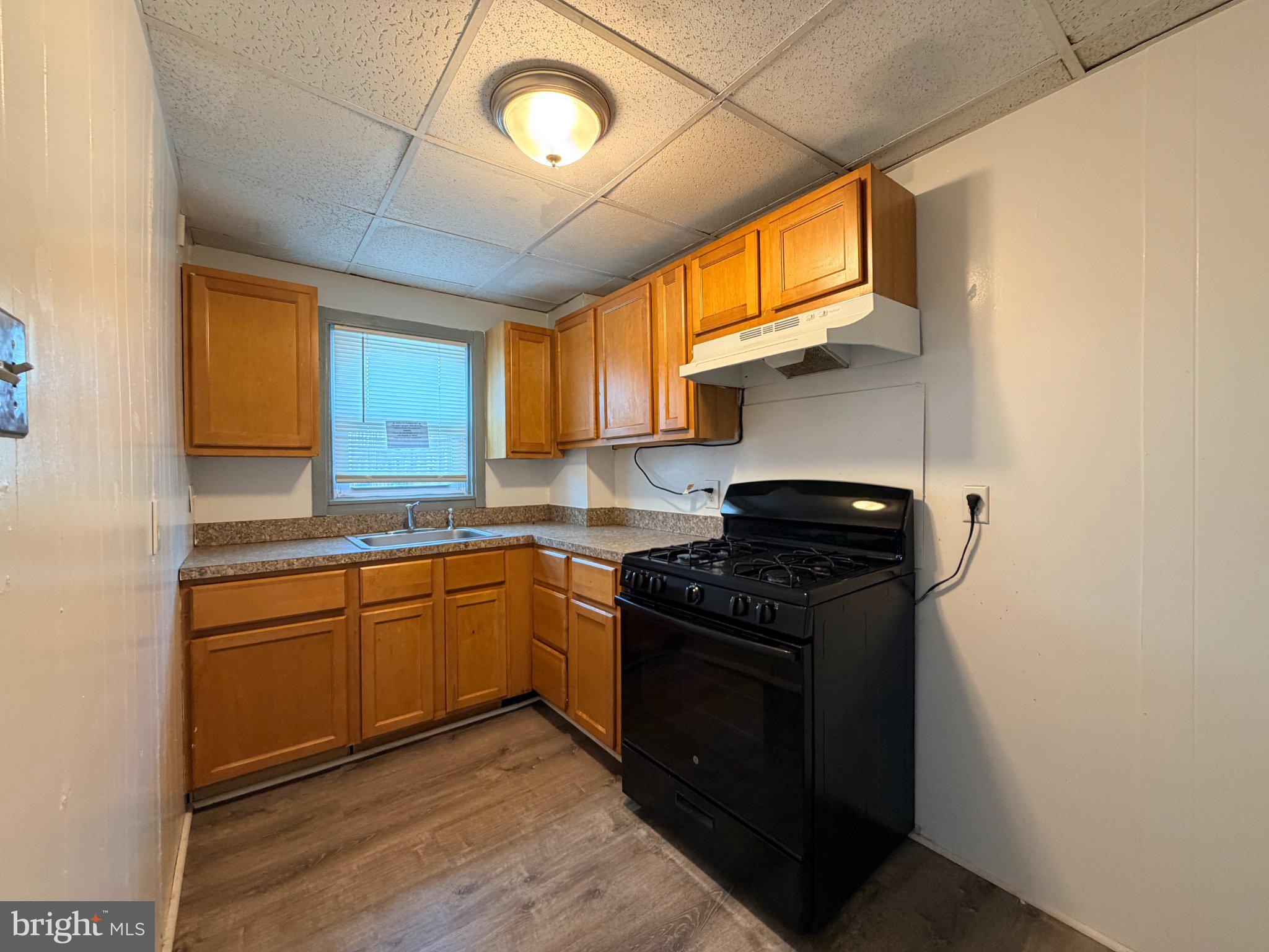 916 Butler Street Chester, PA 19013 - Photo 4 of 11 Cozy kitchen with warm wood tones.