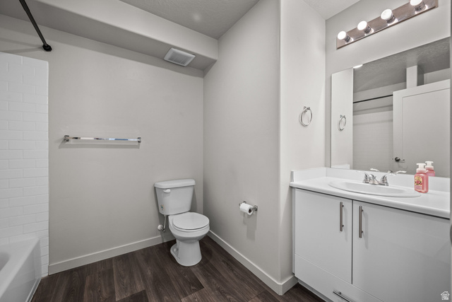 1700 South Sandhill Road West, Unit E 301 Orem, UT 84058 - Photo 14 of 20 Bathroom featuring a white vanity with integrated sink, a rectangular wall-mounted mirror, and a five-bulb vanity light fixture