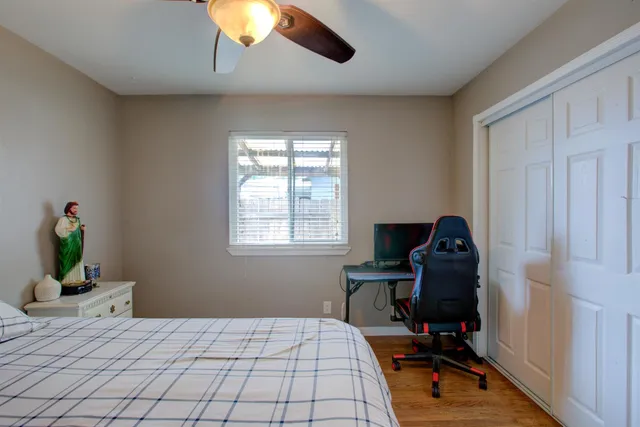 a bedroom with a bed and a window