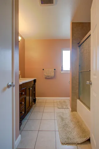 a bedroom with a bed and a flat tv screen on dresser