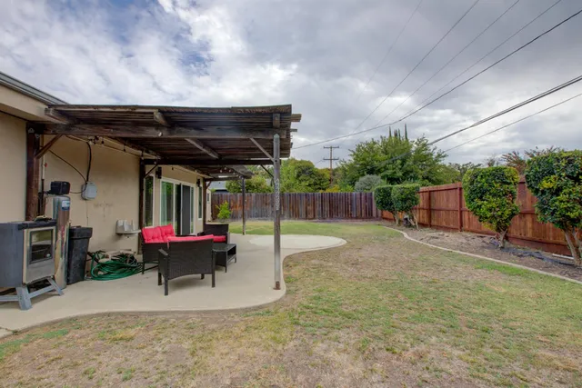 an aerial view of a house with garden space and street view