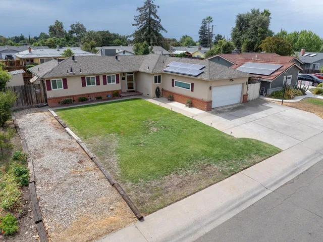 an aerial view of a house with a yard
