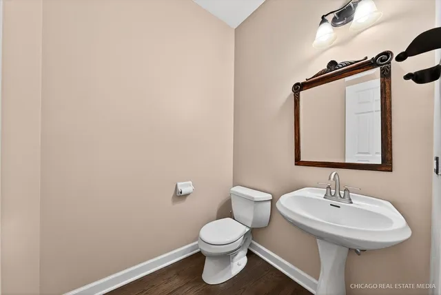 a view of a hallway view with wooden floor and staircase