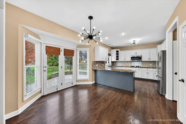 a kitchen with stainless steel appliances a sink stove and refrigerator