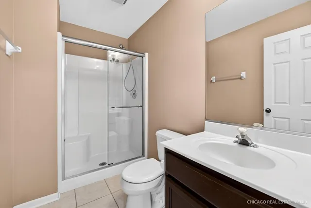 a bedroom with a large bed couch and a window