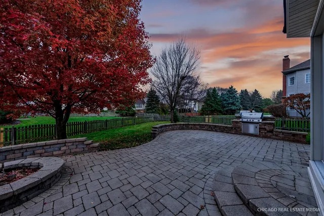 an aerial view of residential houses with outdoor space and trees