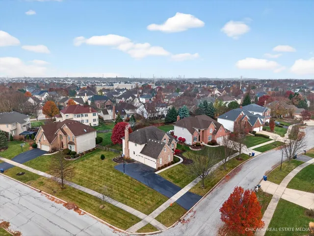 a view of a house with a yard and garage