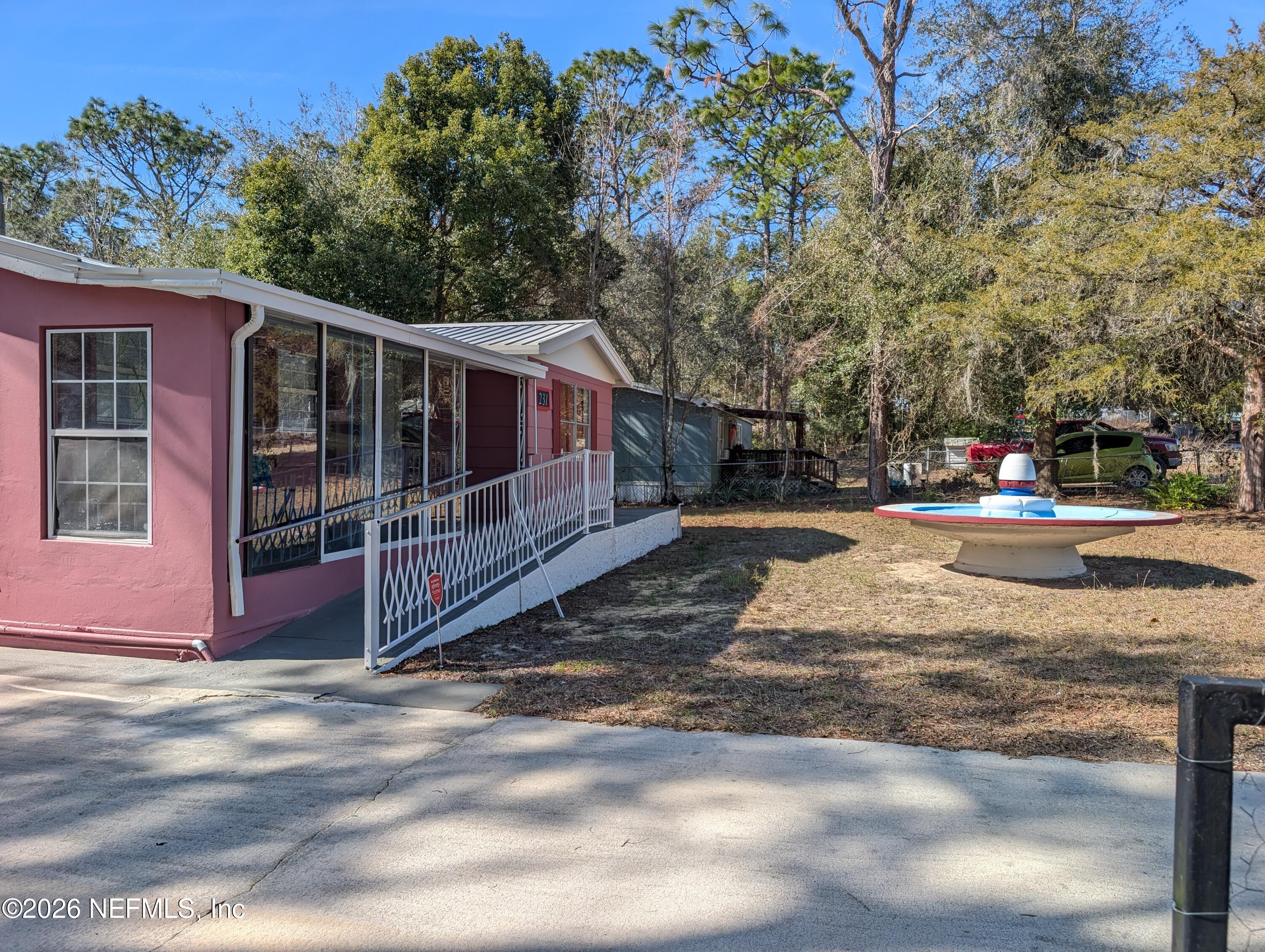231 5th Way Interlachen, FL 32148 - Photo 3 of 22 231 5TH WAY BEAUTIFUL FRONT YARD