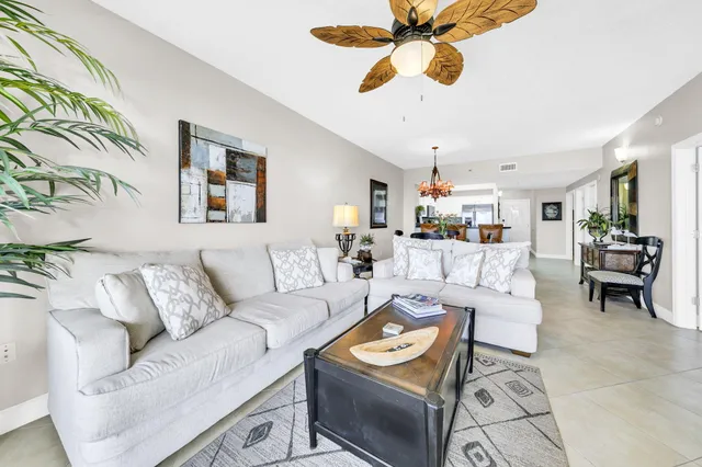a living room with furniture a rug and a chandelier