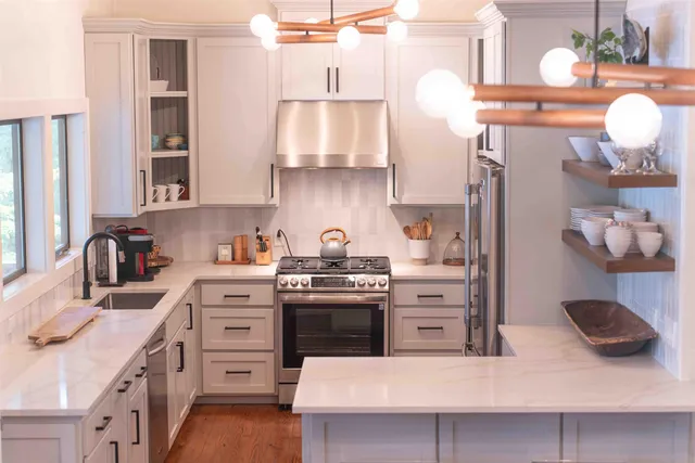 a living room with a bed furniture and a large window