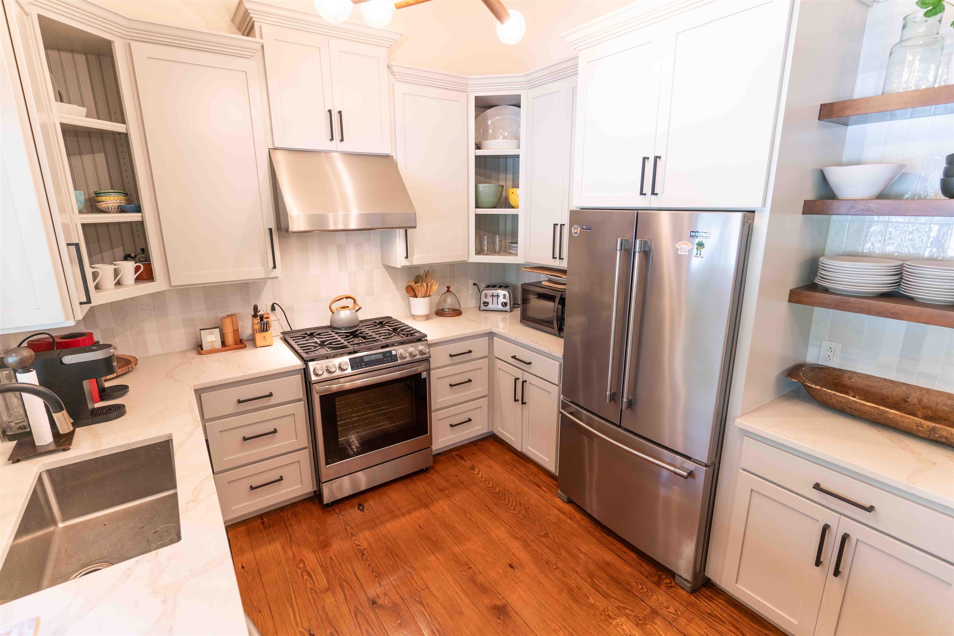 150 Turley Lane Counce, TN 38326 - Photo 11 of 35 Kitchen with open shelves, stainless steel appliances, under cabinet range hood, and backsplash