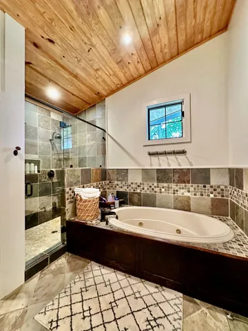 a spacious bedroom with a bed couch and a window