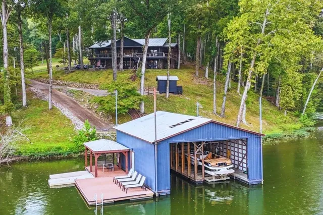 a view of house with swimming pool yard fire pit and outdoor seating