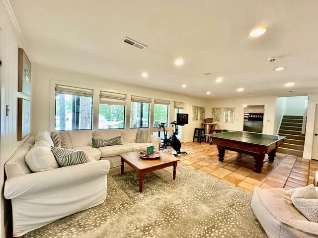 a bedroom with furniture and wooden floor