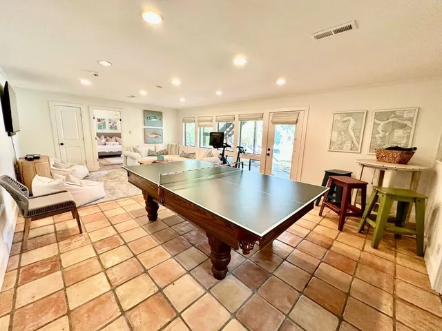 a view of a porch with furniture and wooden floor