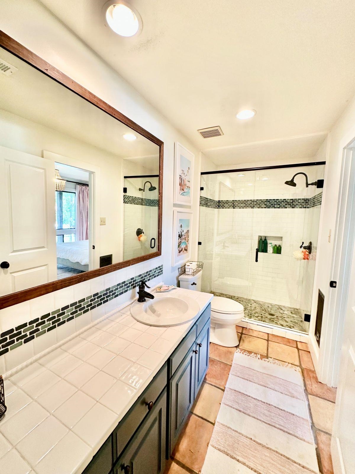 150 Turley Lane Counce, TN 38326 - Photo 22 of 35 a spacious bathroom with a double vanity sink a mirror and a shower