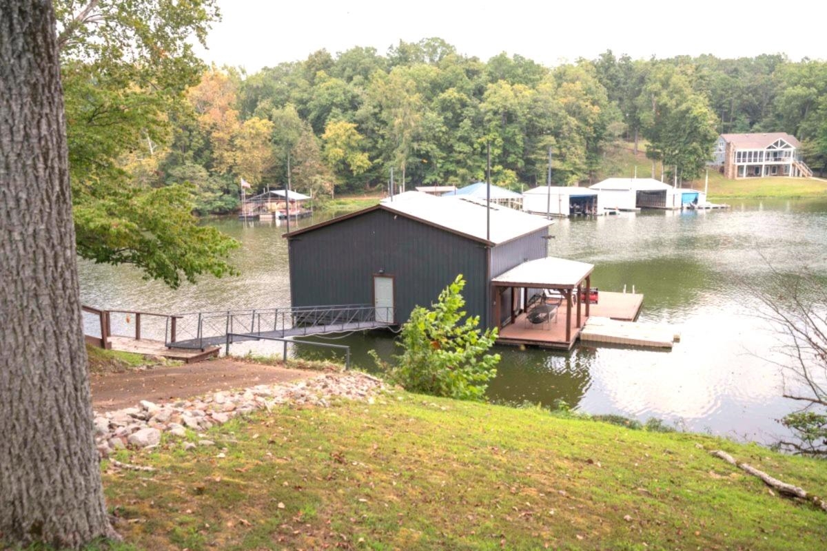 150 Turley Lane Counce, TN 38326 - Photo 32 of 35 a view of a lake with a house in the background