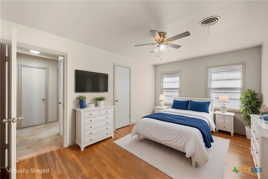 1612 South 49th Street Temple, TX 76504 - Photo 11 of 24 a bedroom with a bed and a flat screen tv