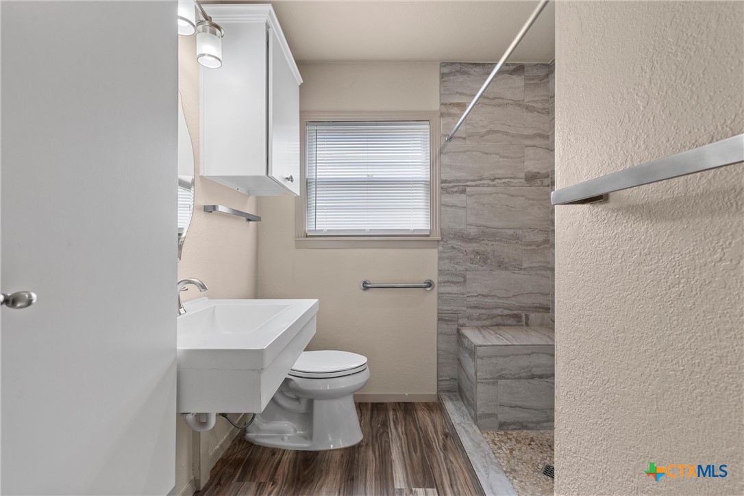 1612 South 49th Street Temple, TX 76504 - Photo 13 of 24 a bathroom with a toilet and a shower