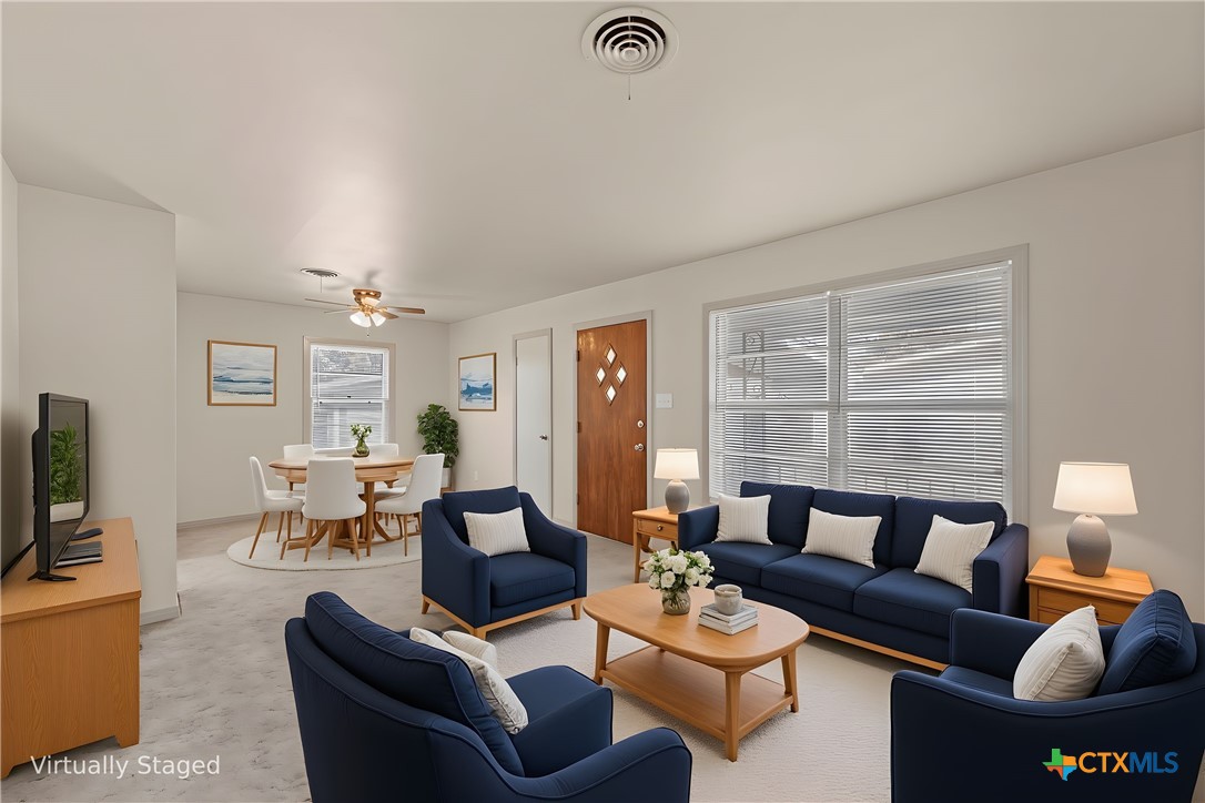 1612 South 49th Street Temple, TX 76504 - Photo 3 of 24 a living room with furniture wooden floor and a flat screen tv