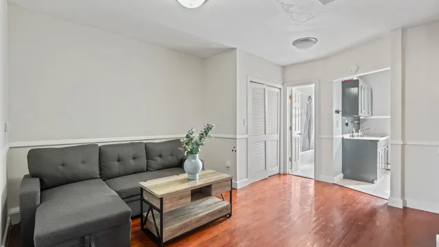 a living room with furniture and wooden floor