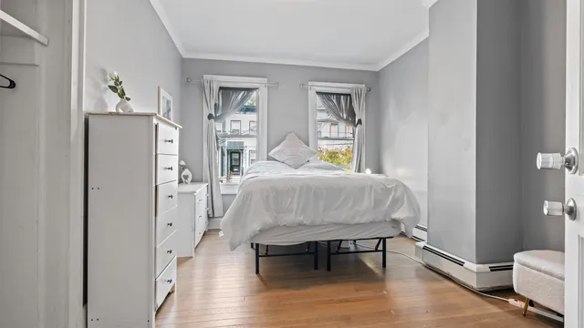 a bedroom with a bed and a mirror