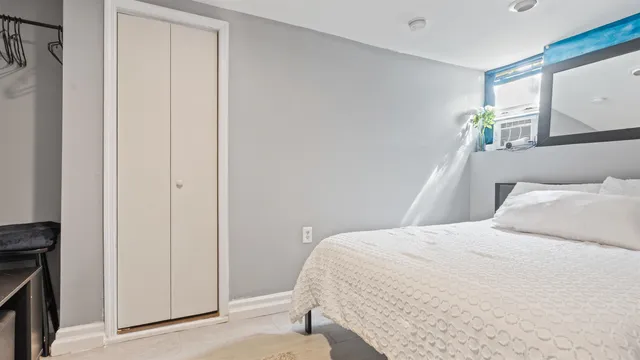 a bedroom with a bed and a window