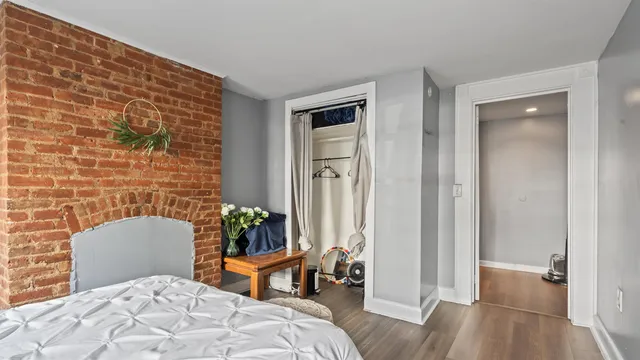 a bedroom with a bed and a mirror