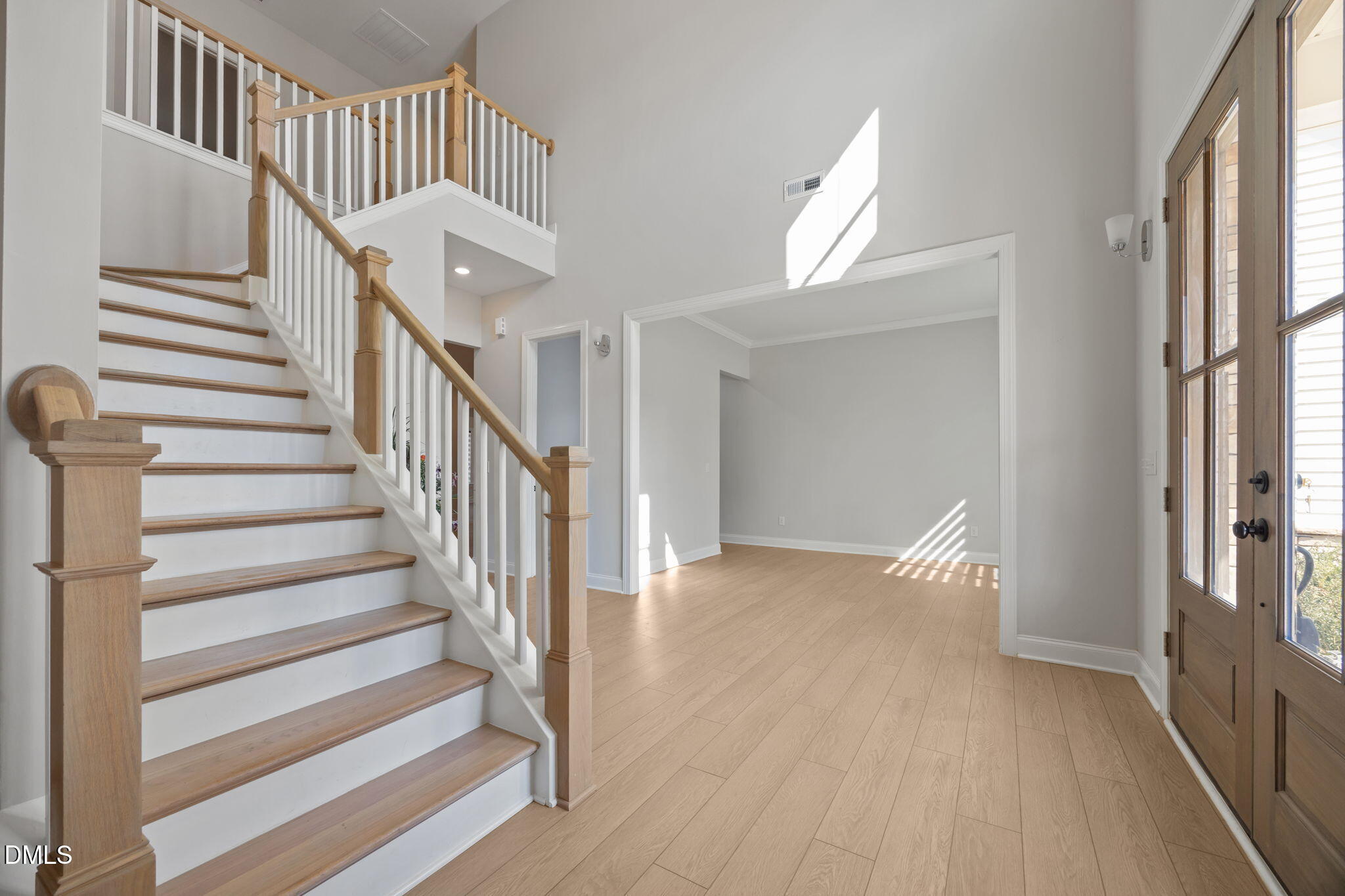 188 Flight Pattern Way Garner, NC 27529 - Photo 19 of 41 a view of staircase with lots of frames on wall and wooden floor