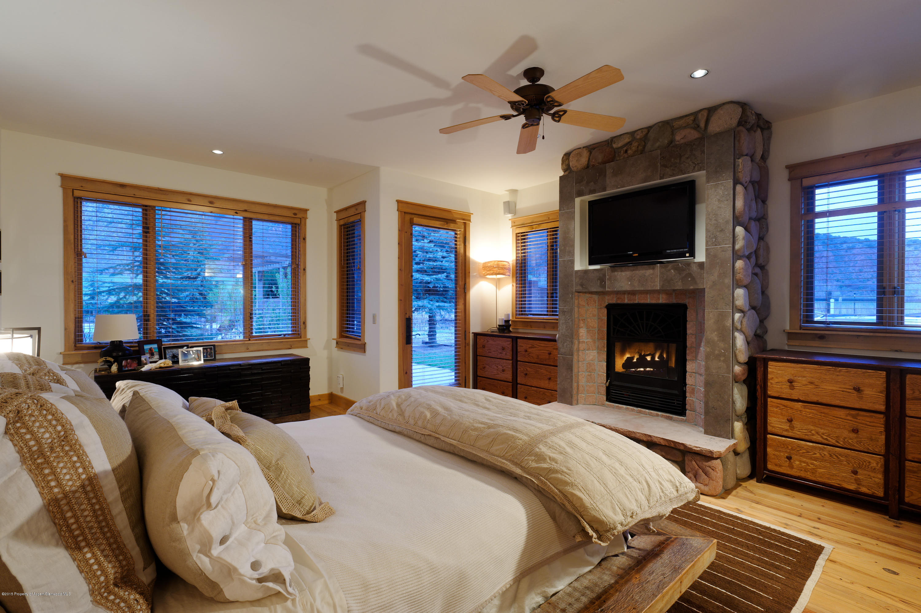 298 Red Rock Road Basalt, CO 81621 - Photo 18 of 30 a spacious bedroom with a bed and wooden floor