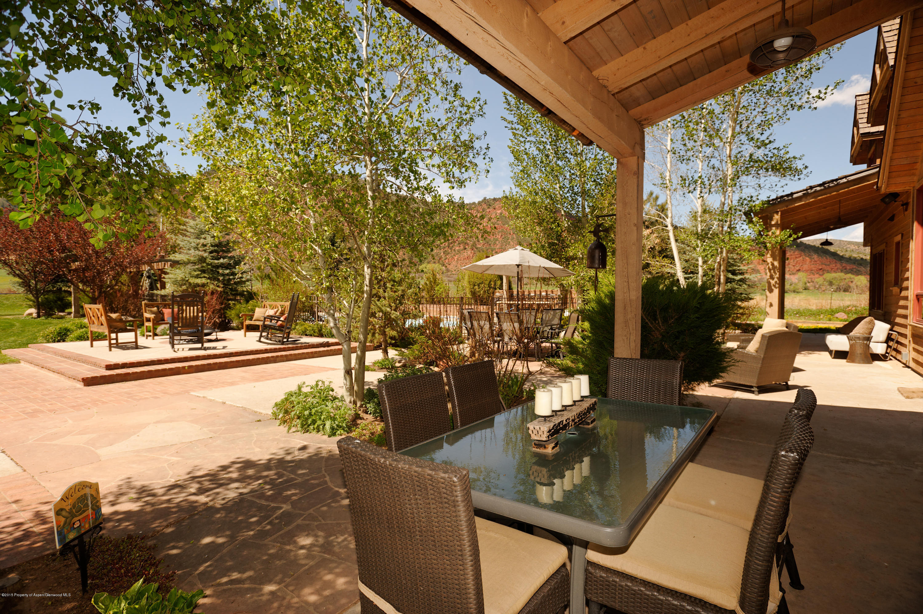 298 Red Rock Road Basalt, CO 81621 - Photo 5 of 30 a view of a patio with couches table and chairs and potted plants