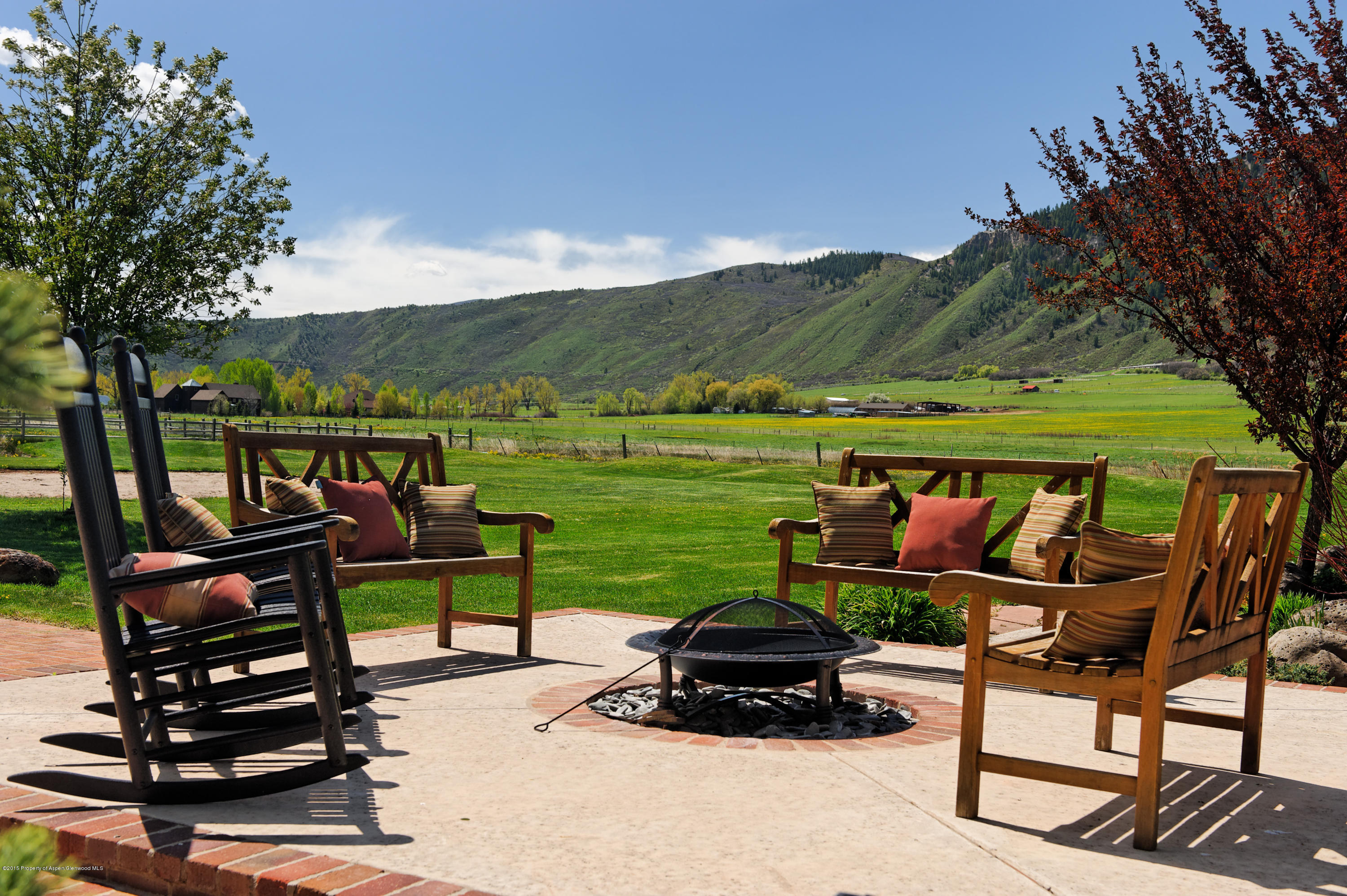 298 Red Rock Road Basalt, CO 81621 - Photo 7 of 30 a roof deck with table and chairs a barbeque and a yard with a large tree