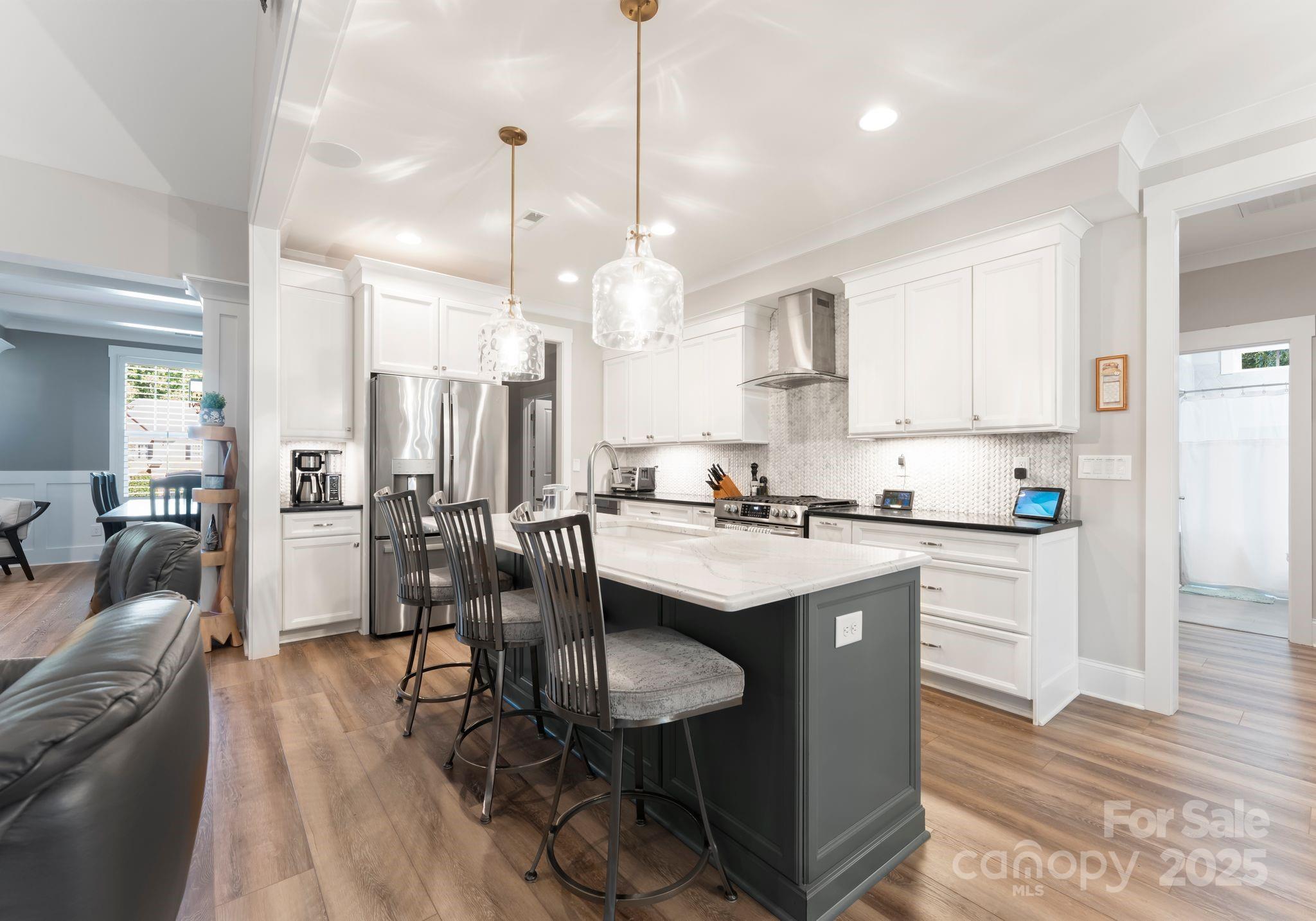 4275 Silver Eagle Cove Denver, NC 28037 - Photo 12 of 48 a kitchen with stainless steel appliances granite countertop a table chairs sink refrigerator and cabinets