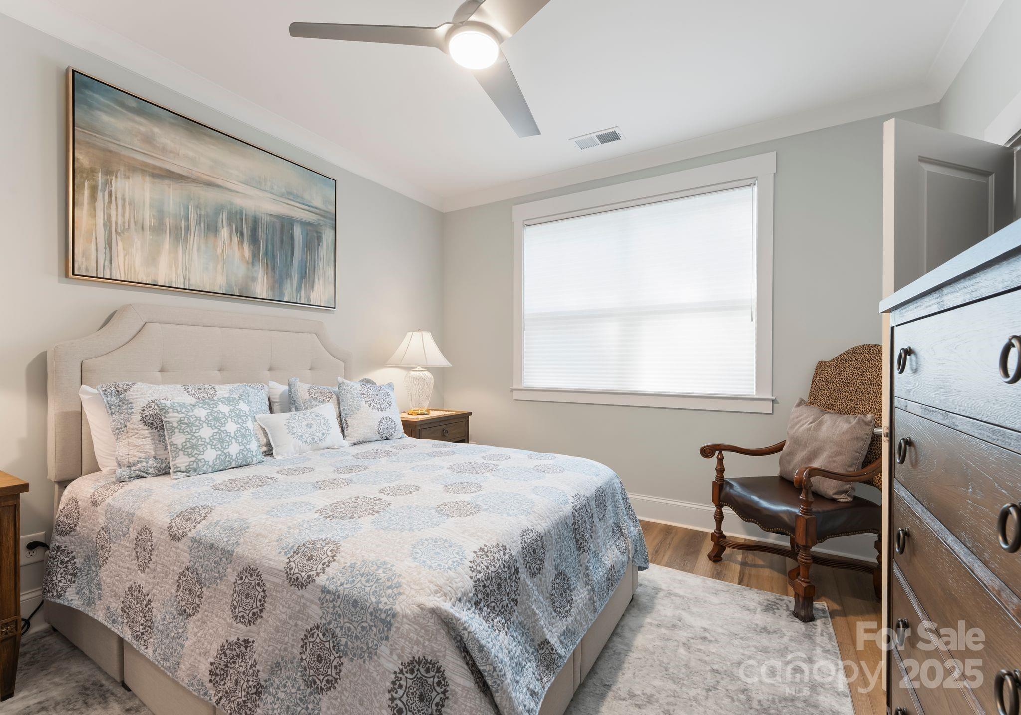 4275 Silver Eagle Cove Denver, NC 28037 - Photo 21 of 48 a bedroom with a bed and wooden floor