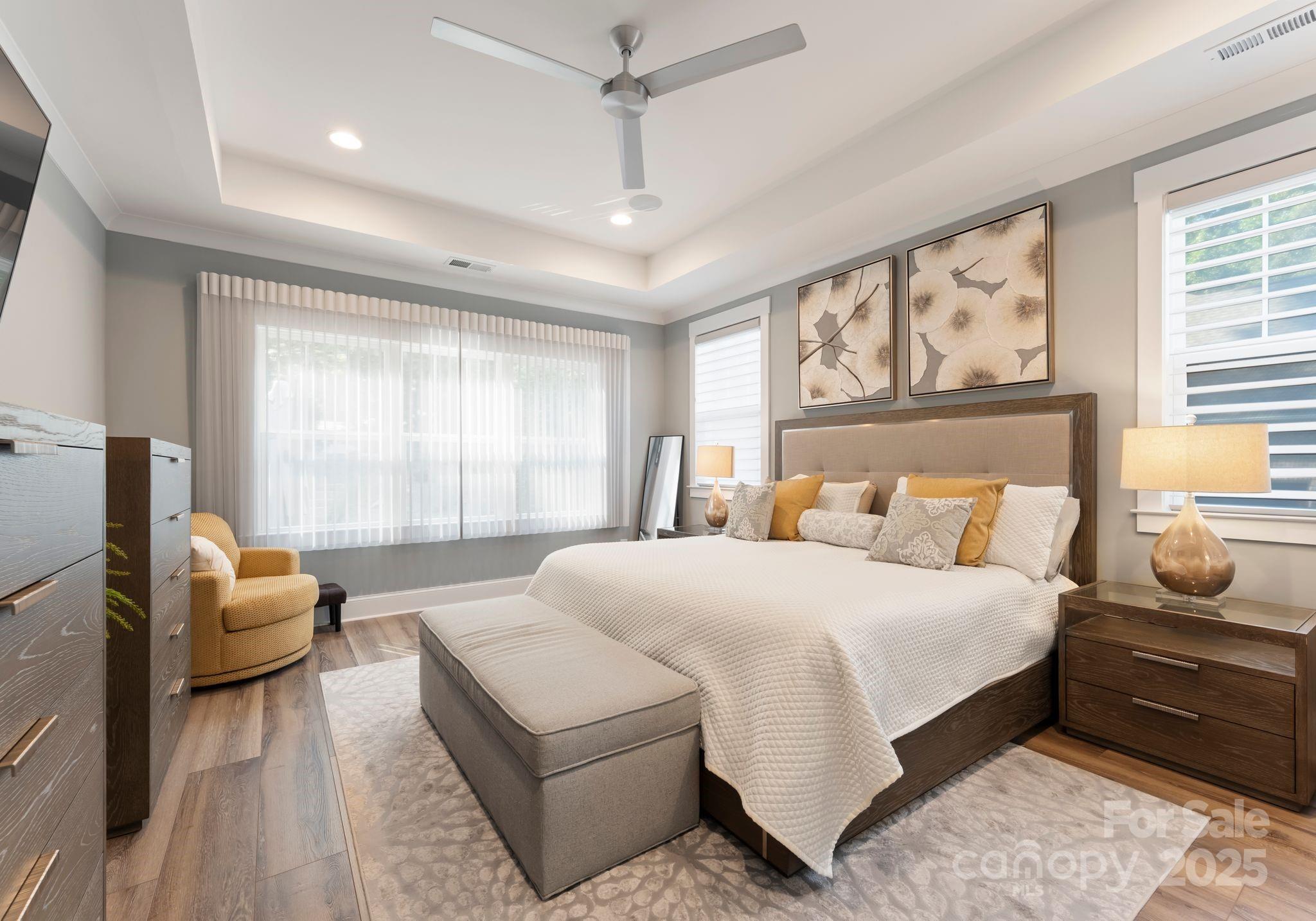 4275 Silver Eagle Cove Denver, NC 28037 - Photo 29 of 48 a bedroom with a large bed couch and windows