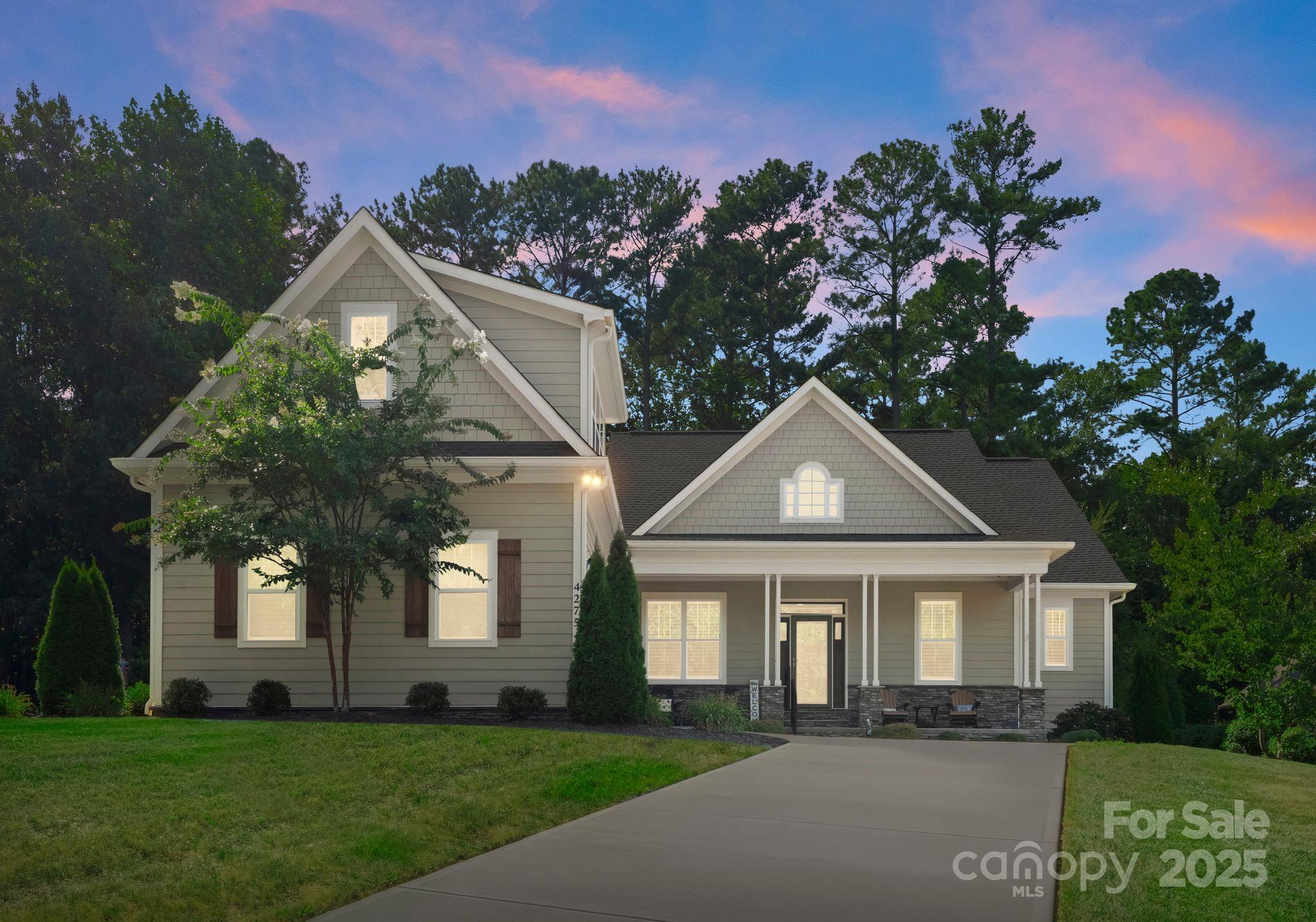 4275 Silver Eagle Cove Denver, NC 28037 - Photo 43 of 48 a front view of a house with a yard and trees
