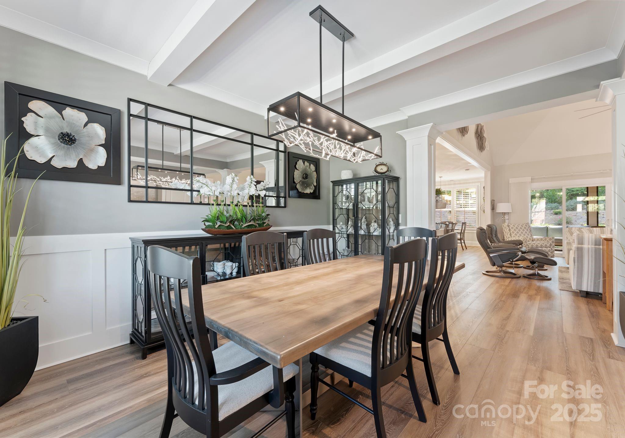 4275 Silver Eagle Cove Denver, NC 28037 - Photo 7 of 48 a view of a dining room and livingroom with furniture wooden floor a chandelier