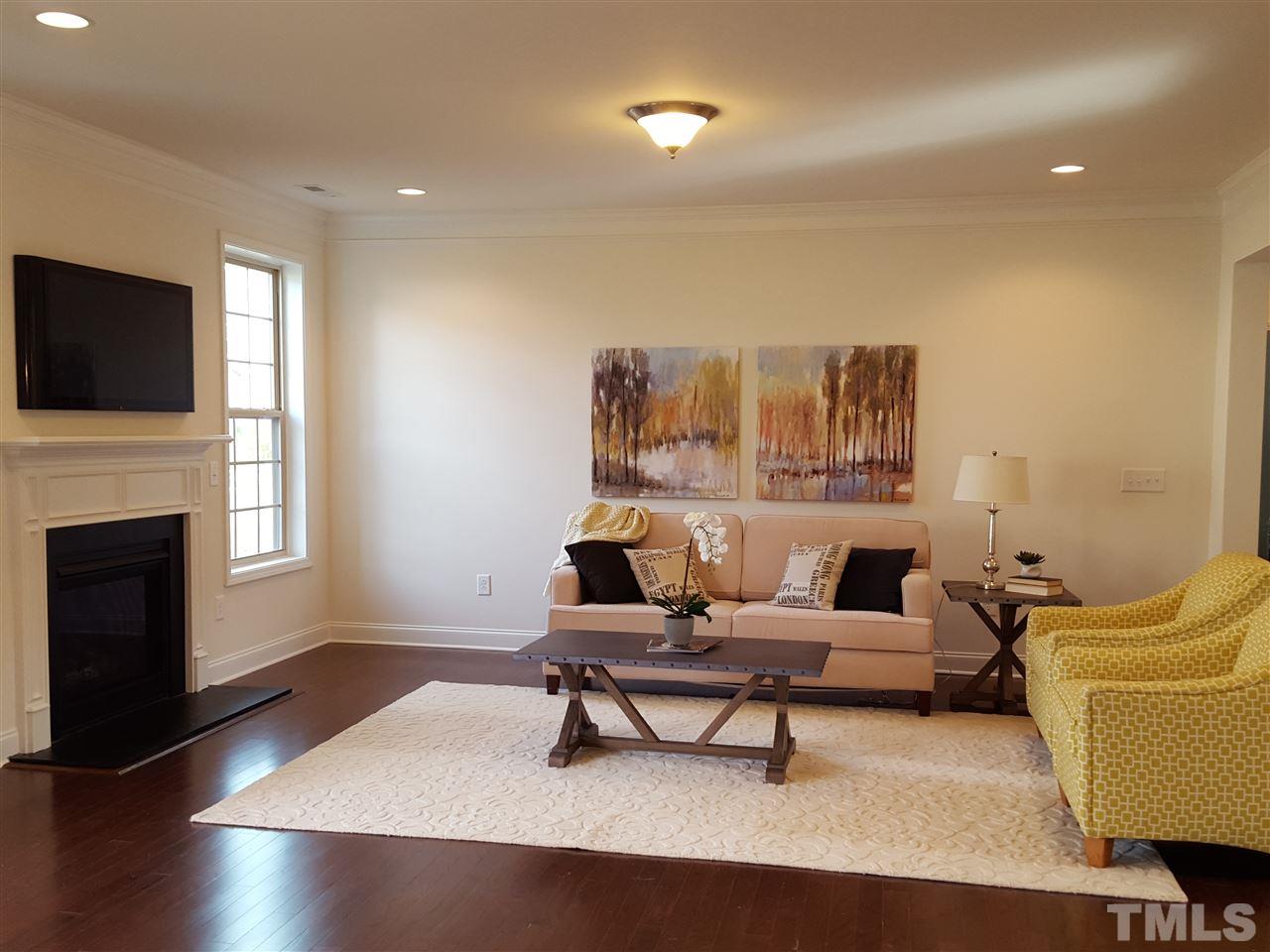 7633 Channery Way Raleigh, NC 27616 - Photo 7 of 25 a living room with furniture and a fireplace