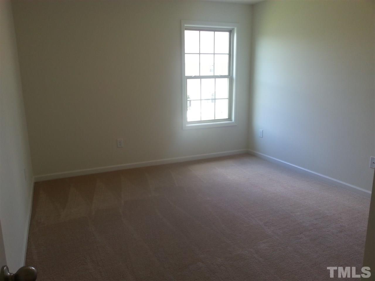 7633 Channery Way Raleigh, NC 27616 - Photo 8 of 25 an empty room with a window