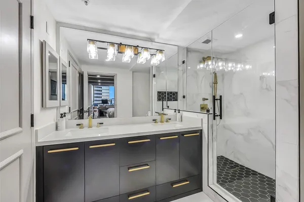 a bathroom with a sink a toilet a shower and a mirror