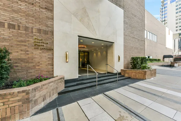 a view of lobby with painting and a potted plant