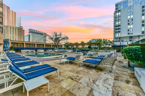 a view of a backyard with furniture and plants