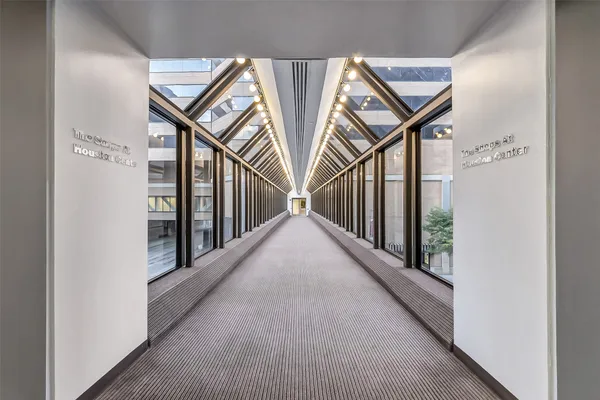 a living room with furniture a chandelier and a dining table