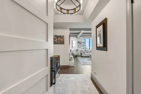 a living room with lots of furniture and kitchen view