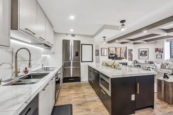 a kitchen with a stove and a wooden floor