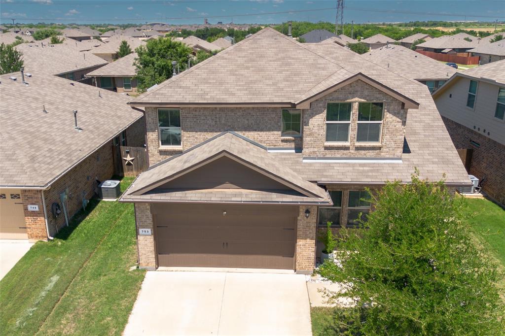 753 Rutherford Drive Crowley, TX 76036 - Photo 2 of 26 Two-story residence featuring a brick facade, shingle roof, and an integrated two-car garage