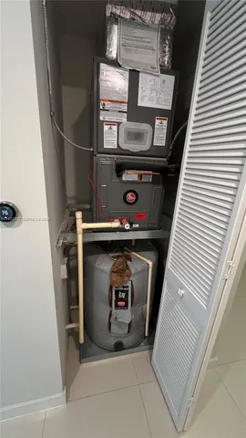 a kitchen with granite countertop a refrigerator and a sink