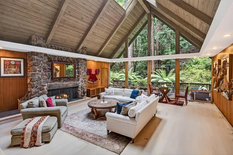 a living room with furniture and a floor to ceiling window