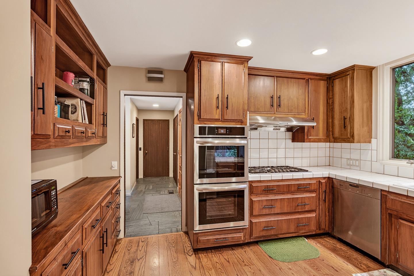 573 Patrol Road Woodside, CA 94062 - Photo 7 of 18 a kitchen with a refrigerator stove and cabinets