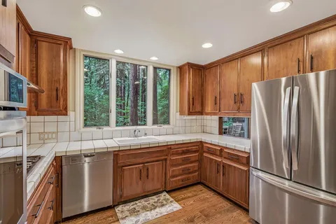a kitchen with a refrigerator and a sink